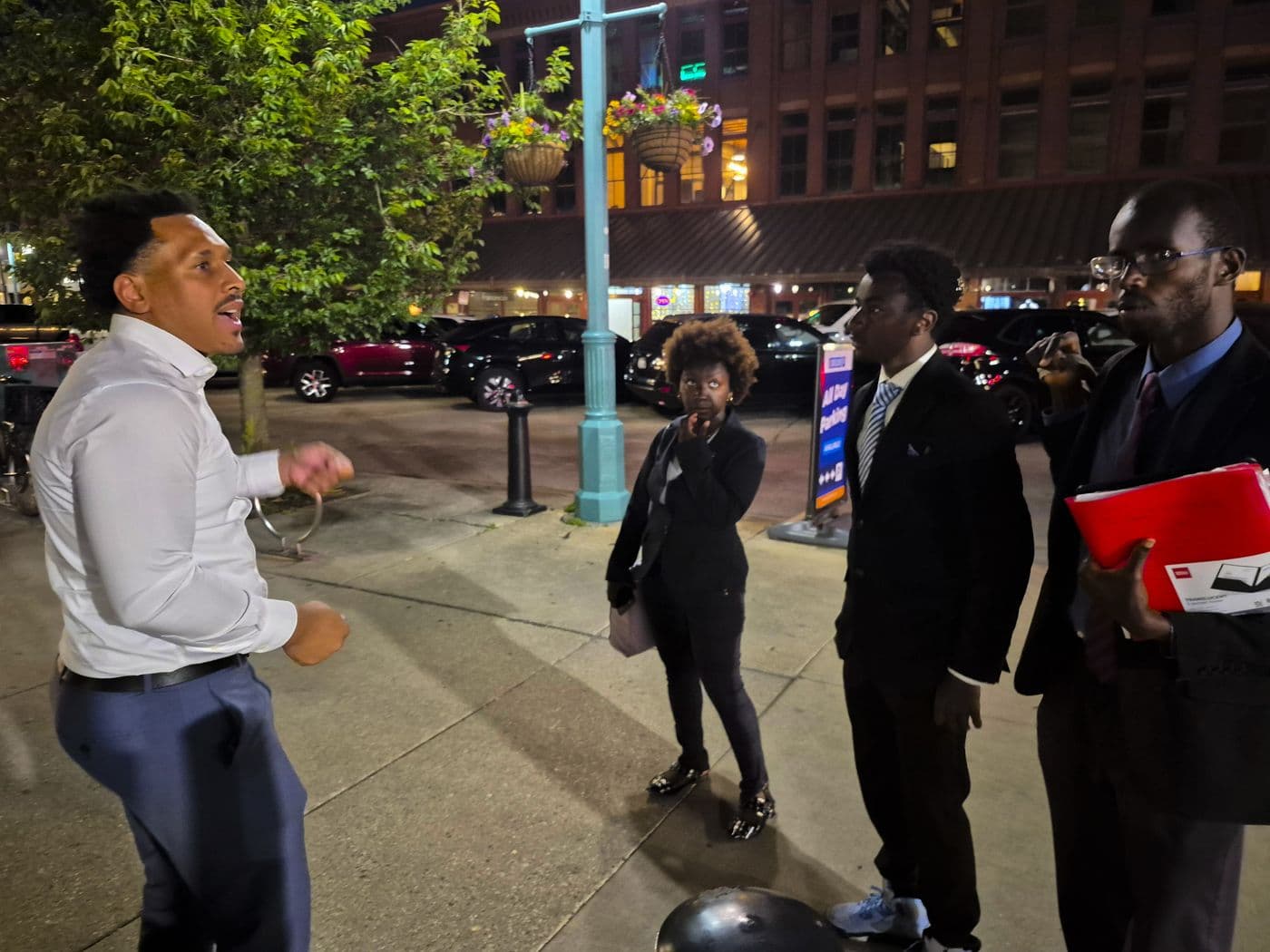 GLO team members talking with a supporter during an evening outreach shift