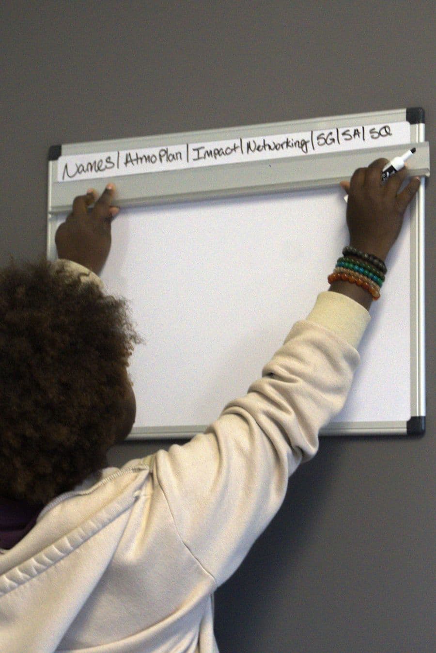 A GLO team member mapping out the day's plan on a whiteboard